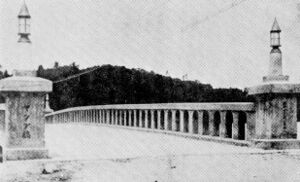 Japanese-era postcard depicting a substantial masonry bridge on Yap. Its scale and form strongly suggest the Tomil Harbor crossing between Colonia and Rul, the predecessor of Ganir Bridge.