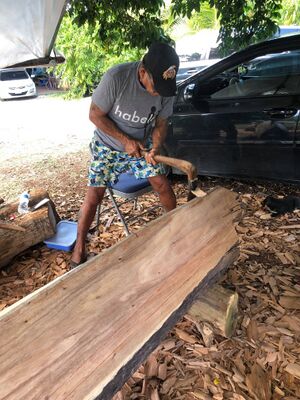 Satawallese Carver on Saipan with Adze Copyright Habele.jpg